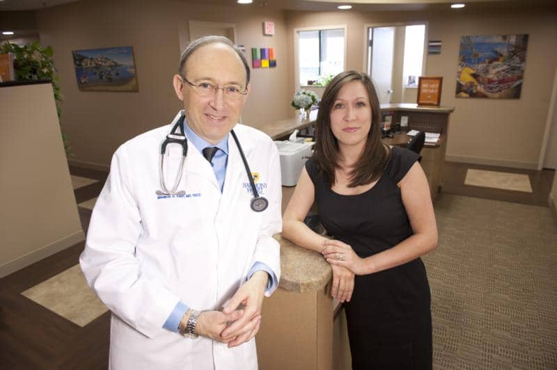 Mordecai N. Klein, MD, FACC with office manager in Plano TX cardiology office