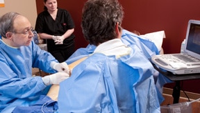 nurse viewing monitor along with Dr. Klein during a varicose vein procedure in Plano TX
