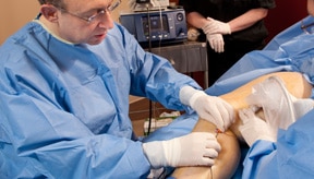 Dr. Klein mapping out the veins on a patients leg in Plano TX