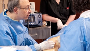 Mordecai N. Klein, MD, FACC shown viewing monitor during spider vein removal procedure in Plano TX