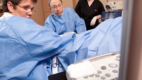 Mordecai N. Klein, MD, FACC pictured with nurse conducting a sclerotherapy procedure in Plano TX